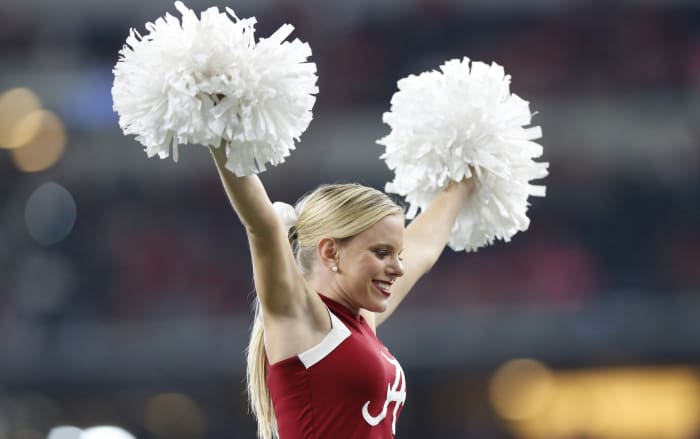 Alabama Crimson Tide cheerleader at a college football game in the SEC with a place in the top 25 rankings on the line.